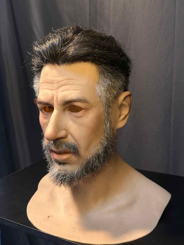 Left side of hyper realistic mask displaying natural skin folds and realistic expression.