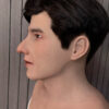 Left profile of a realistic silicone face mask with black hair