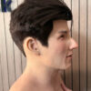 Right profile of a black-haired silicone lifelike face mask