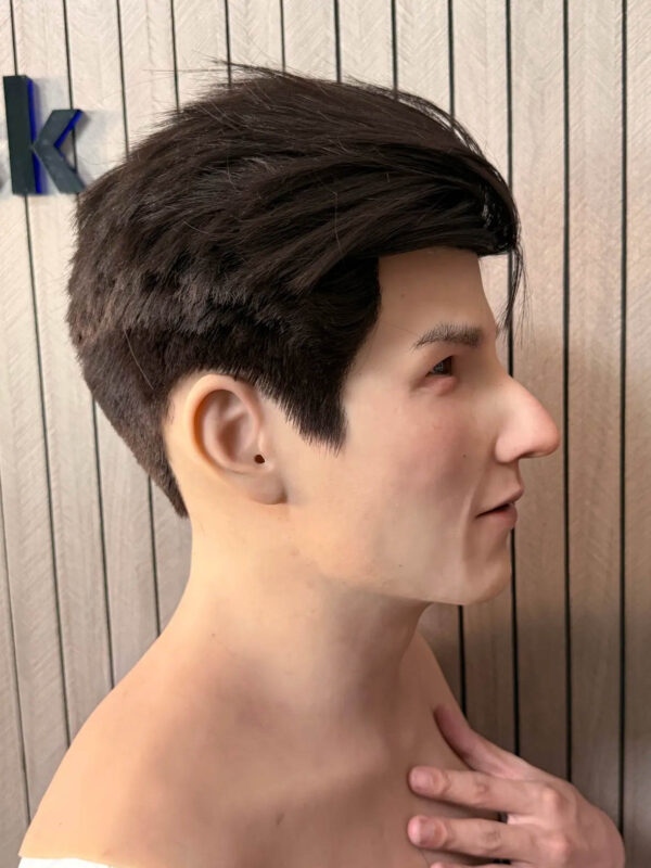 Right profile of a black-haired silicone lifelike face mask