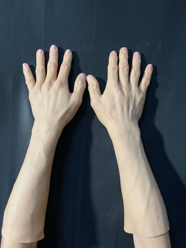 Front view of realistic silicone gloves showing lifelike skin texture and nail detail