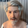 Man wearing realistic silicone masks of elderly character front view