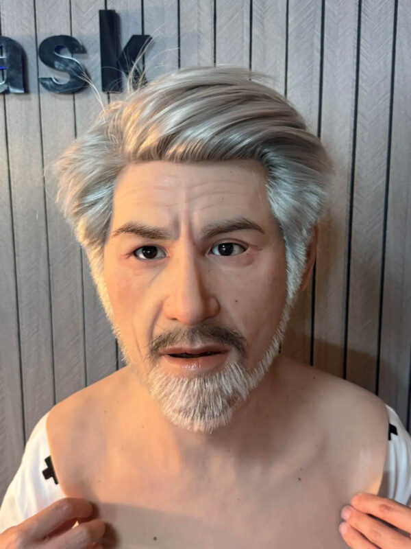 Man wearing realistic silicone masks of elderly character front view