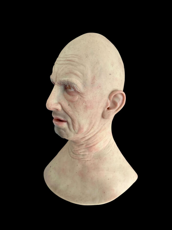 Side angle of elderly man silicon mask with detailed wrinkles