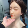 Silicone masks female right side profile displaying detailed skin texture and hairstyle